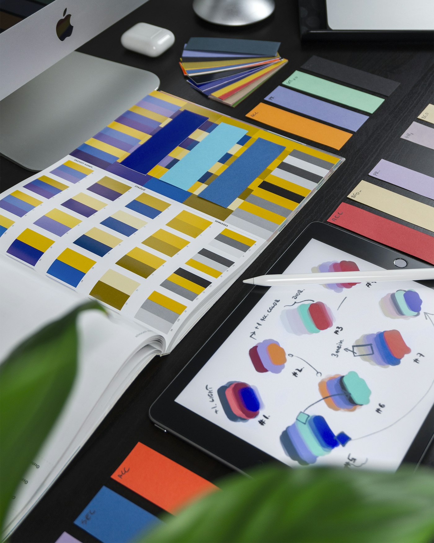 Colour palettes and brand colour exploration on a designer's desk